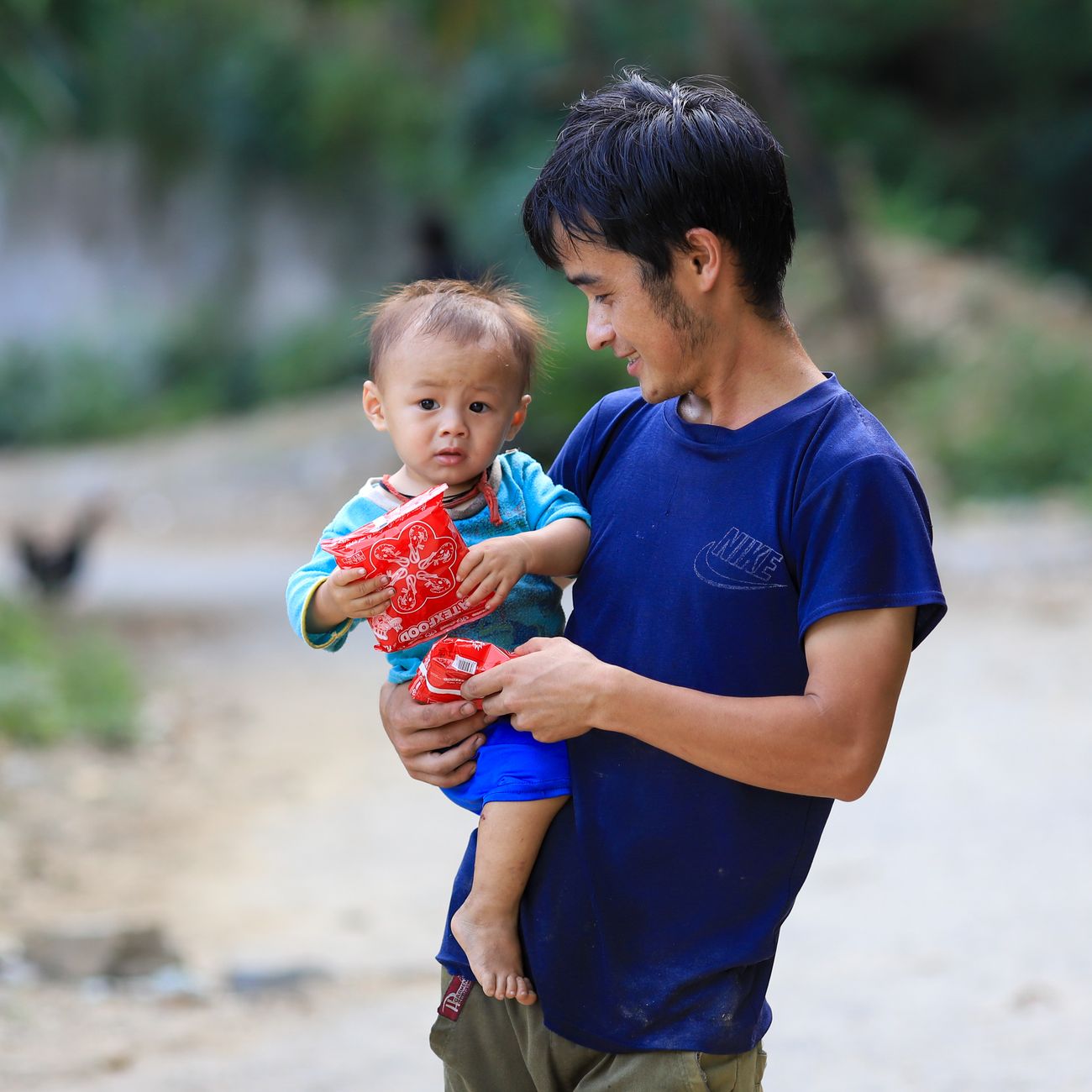 A father and young son sharing a quiet outdoor moment together